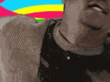 a close up of a person 's face with a rainbow background