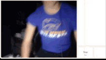 a blurred image of a person wearing a blue shirt that says olympians