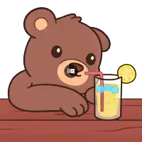a brown teddy bear drinking a glass of lemonade
