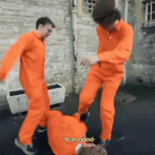two men in orange jumpsuits are standing next to each other and one of them is saying yeah good