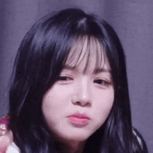 a close up of a girl making a funny face with her mouth open .