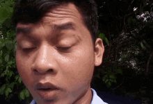 a close up of a man making a funny face with his eyes closed
