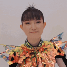 a woman in a colorful costume is making a face and giving the middle finger