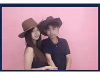a man and a woman wearing cowboy hats are posing for a picture