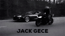 a black and white photo of a man riding a motorcycle next to a car with the name jack gece
