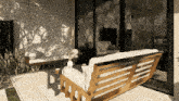 a couch with a white cushion sits on a patio in front of a window