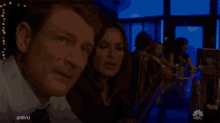 a man and a woman are sitting at a bar with the hashtag #svu on the bottom