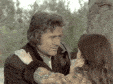 a man and a woman are hugging each other