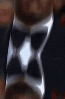 a close up of a person wearing a silver ring with a black and white design on it .