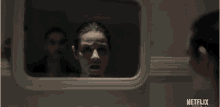 a woman is looking at herself in a mirror with netflix written on the bottom right