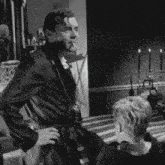 a man in a robe is smoking a cigarette while standing next to another man