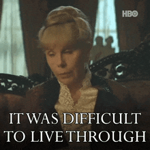a woman sitting on a couch with the words it was difficult to live through