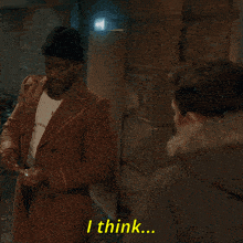 a man in a plaid coat says " i think " while pointing at another man in a green jacket