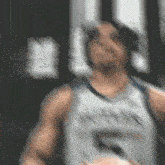 a blurry picture of a man wearing a tank top with the number 5 on it