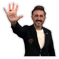 a man with a rose pin on his jacket is waving