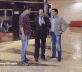 three men are standing next to each other with the website sonyliv.com in the corner