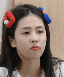 a woman wearing a headband with a penguin on it makes a funny face