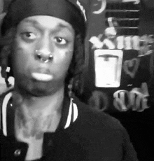 a black and white photo of a man wearing a bandana