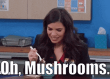 a woman is sitting at a table with a spoon in her mouth and the words uh mushrooms written above her .
