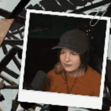 a picture of a woman wearing a baseball cap and a sweater .