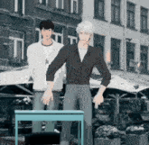 two men standing next to each other with one pointing at a table