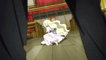 a woman in a white dress is kneeling down in front of a red curtain