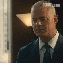 a man in a suit and tie has countdown written on his head