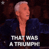 a man in a blue jacket says that was a triumph in front of a crowd