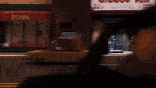 a cartoon character is dancing on a dance floor in front of a man .