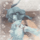 a statue of a woman is taking a selfie in a room with hearts around it .