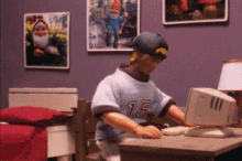 a doll with the number 15 on his shirt is using a computer
