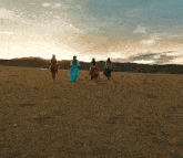 a group of people standing in a field with swords
