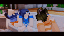 a girl in a blue shirt is sitting on a bed next to two other girls