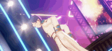 a man in a white coat is standing on a stage in front of a purple and blue background .