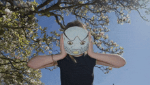 a woman covering her ears with a blue mask