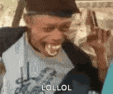 a man is making a funny face with his mouth open and the word lollol written on his face .
