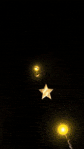a glowing ball is flying through the air with a star behind it
