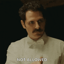 a man with a mustache and bow tie is saying not allowed