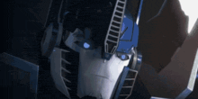 a close up of a transformer with blue eyes .