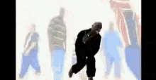 a silhouette of a man dancing in front of a crowd of people