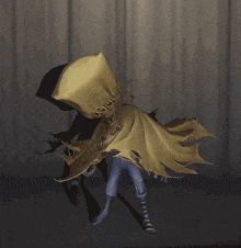 a scarecrow is standing in front of a white curtain holding a pumpkin .