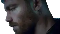 a close up of a man 's face with a smiley face tattoo on his neck