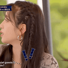a woman with a braid in her hair is wearing hoop earrings and a necklace and says special guests