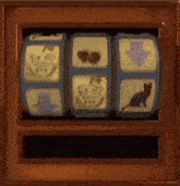 a slot machine with a cat , a pumpkin , a cherry , and an arrow on it .