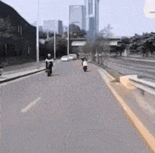 a person is riding a motorcycle down a city street