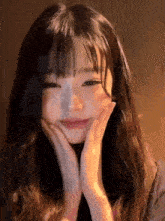 a close up of a woman 's face with her hands on her face