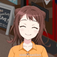 a girl in an orange shirt is smiling with the words viole reaction written below her