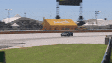 a race car is driving down a track with a yellow roof that says taylor