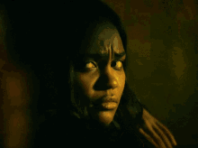a close up of a woman 's face with a hand on her shoulder