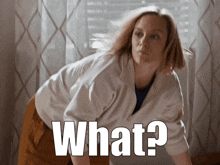 a woman in a white shirt is bending over and the words what are above her